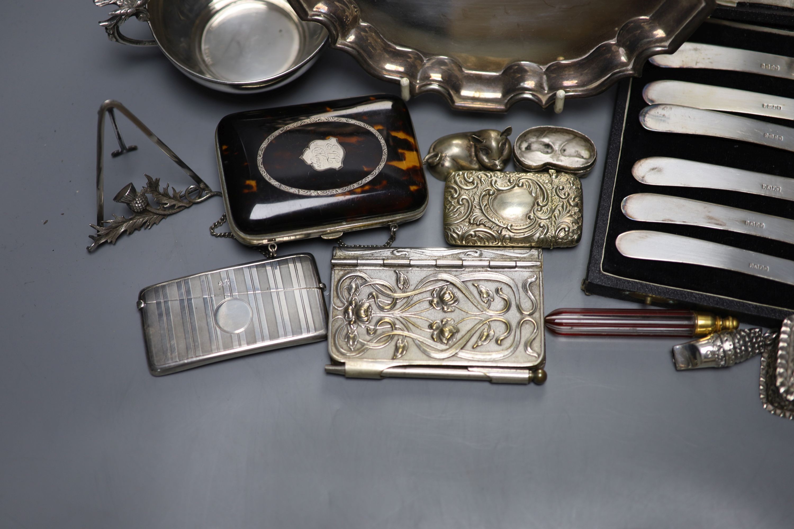 Mixed small silver and plated wares including sterling cup, repousse silver boxes, cased silver teaspoons, silver card case, 925 whistle, plated Art Nouveau aide memoire, plated salver etc.